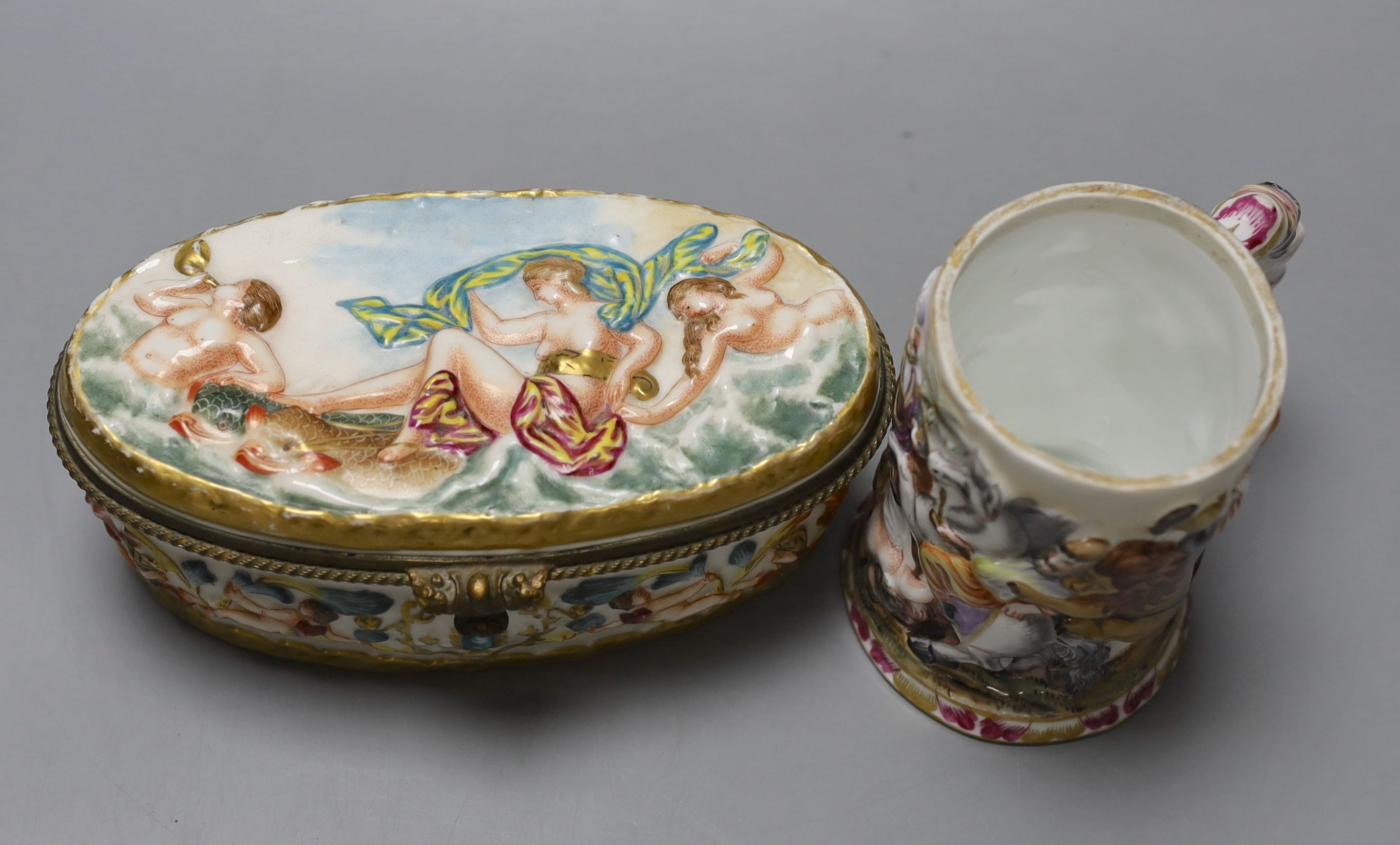 A Doccia style porcelain mug and similar oval casket 18cm